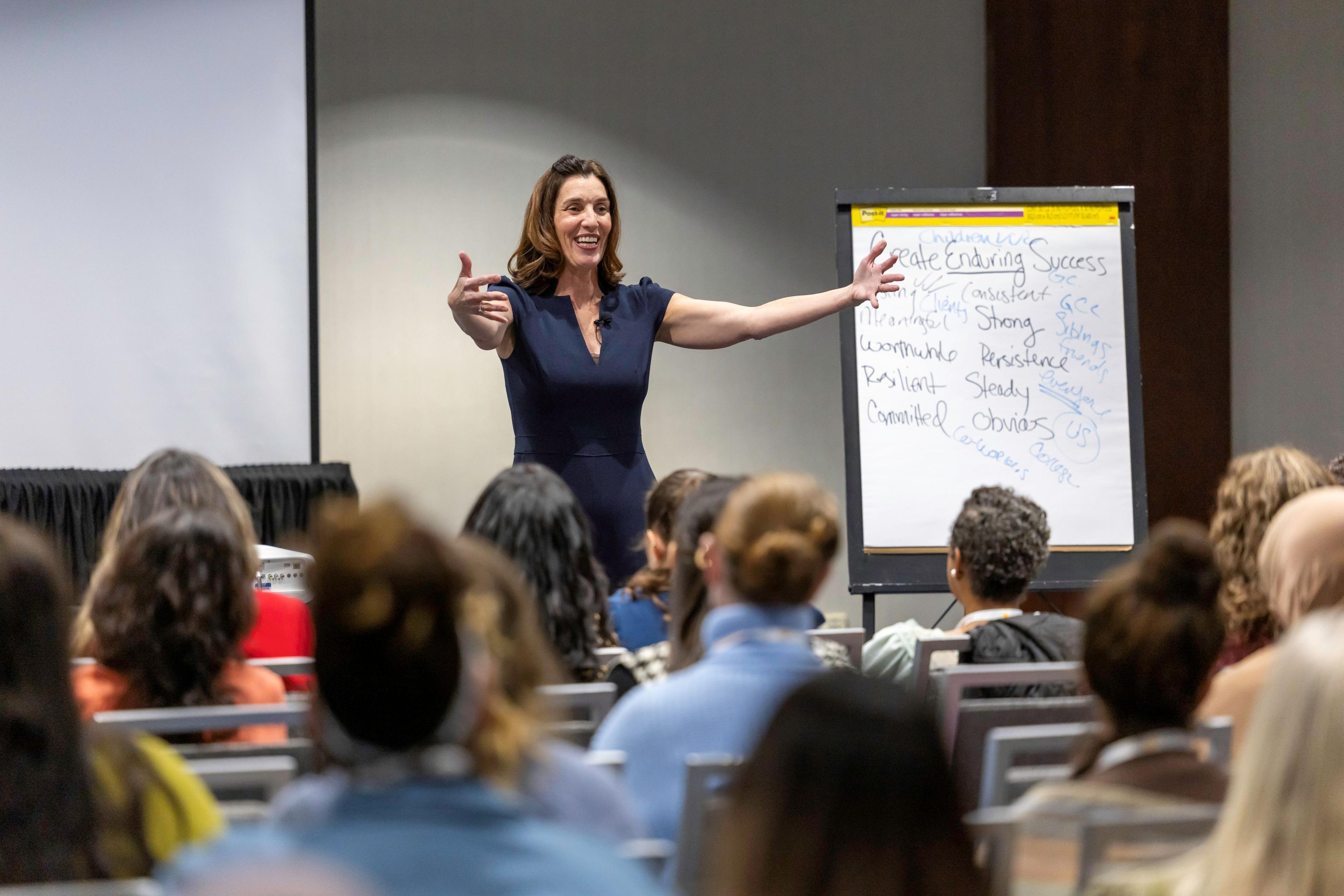 Picture of presenter speaking to attendees in her session.
